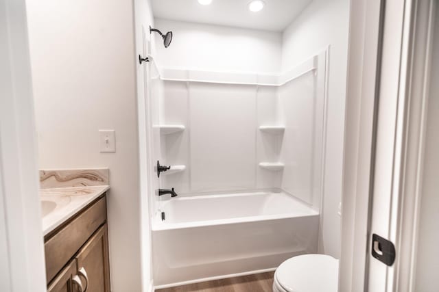 bathroom with shower / washtub combination, vanity, toilet, and wood finished floors