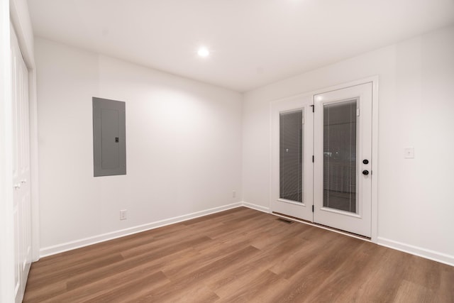 spare room featuring recessed lighting, visible vents, wood finished floors, electric panel, and baseboards