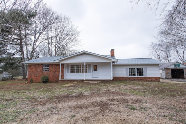 ranch-style house with an outdoor structure and a porch