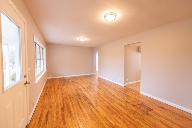 empty room with light hardwood / wood-style flooring