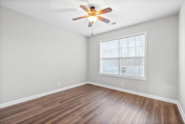 empty room featuring dark wood-type flooring and ceiling fan