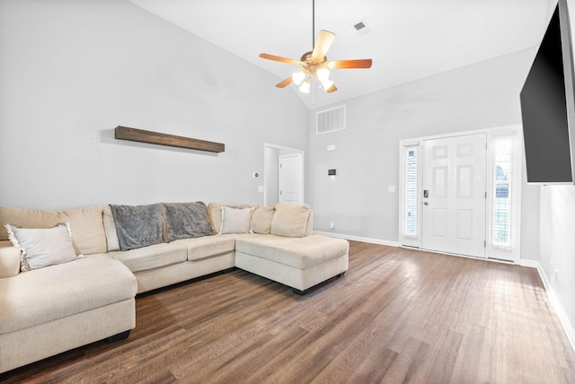 living room with hardwood / wood-style flooring, ceiling fan, and high vaulted ceiling