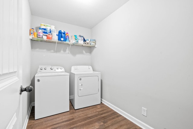 washroom with washing machine and dryer and hardwood / wood-style floors