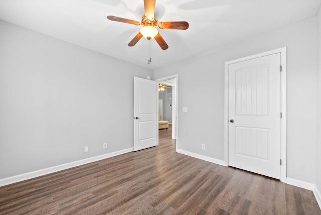 unfurnished bedroom with dark wood-type flooring and ceiling fan