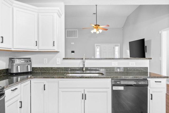 kitchen with dishwasher, sink, dark stone countertops, and white cabinets