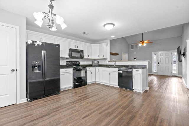 kitchen featuring hanging light fixtures, black appliances, dark hardwood / wood-style floors, and white cabinets