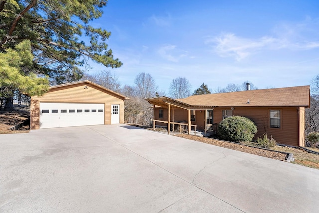 single story home featuring a garage and an outdoor structure