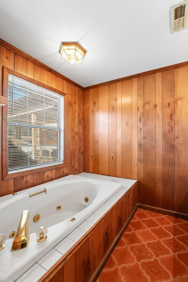 bathroom featuring a tub to relax in and wood walls