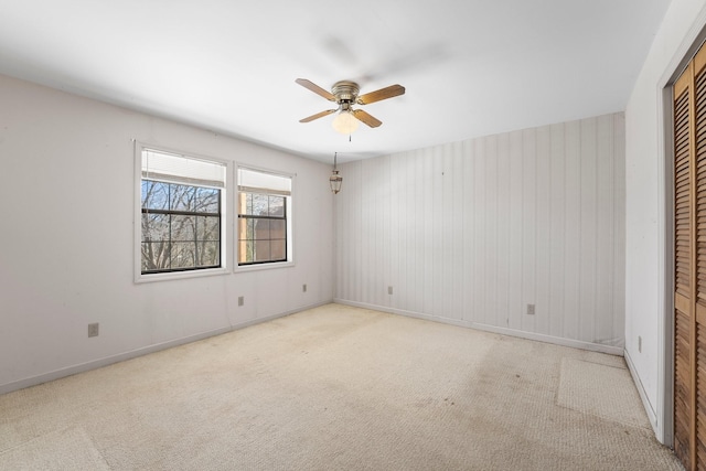 unfurnished bedroom with ceiling fan, light colored carpet, and a closet