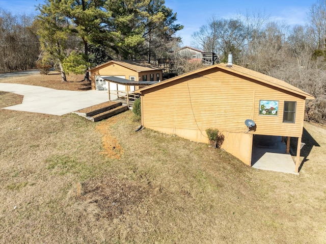 view of side of home with a yard