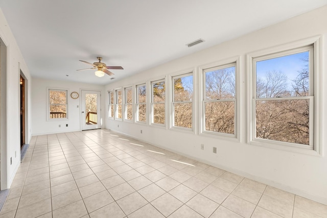 unfurnished sunroom featuring a wealth of natural light and ceiling fan