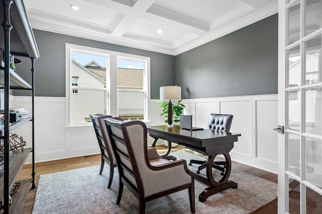 office space featuring dark hardwood / wood-style floors, crown molding, coffered ceiling, and beam ceiling