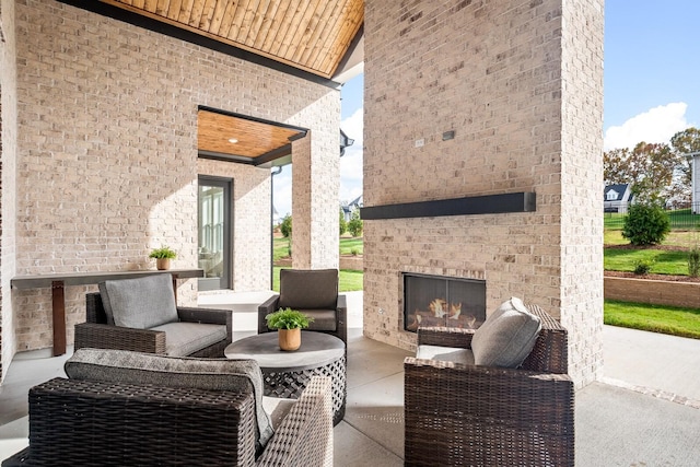 view of patio / terrace with an outdoor brick fireplace