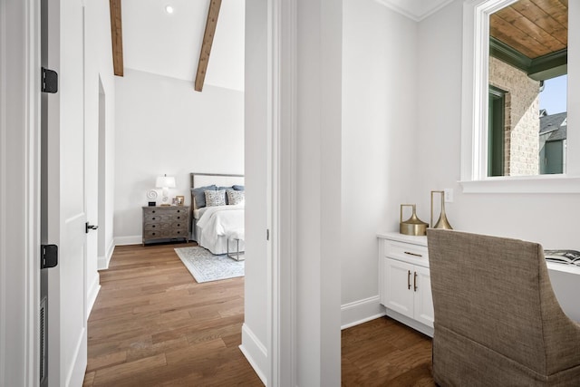 bedroom featuring light hardwood / wood-style flooring and beamed ceiling