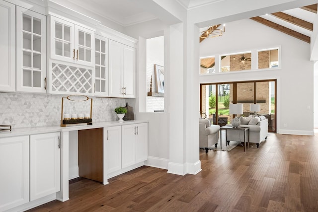 bar with a notable chandelier, dark hardwood / wood-style floors, decorative backsplash, and white cabinets