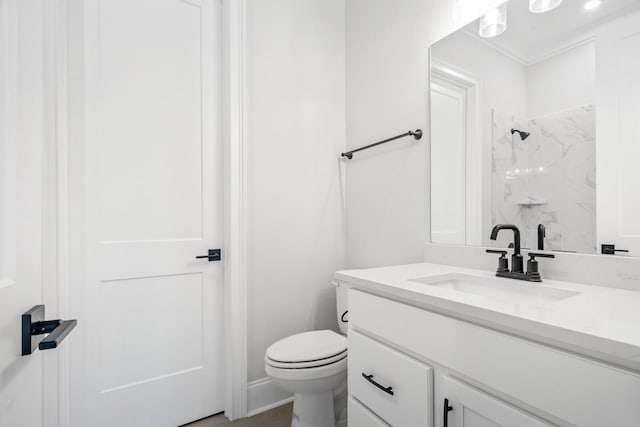 bathroom featuring vanity, toilet, and walk in shower