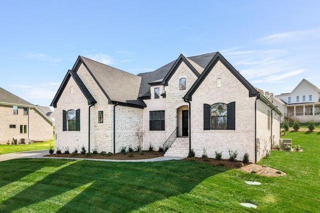 french provincial home featuring a front lawn