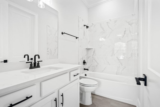 full bathroom featuring vanity, tiled shower / bath combo, crown molding, and toilet