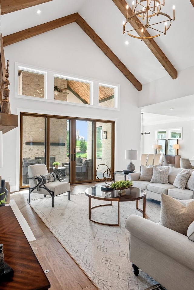 living room featuring hardwood / wood-style flooring, a healthy amount of sunlight, high vaulted ceiling, and beamed ceiling