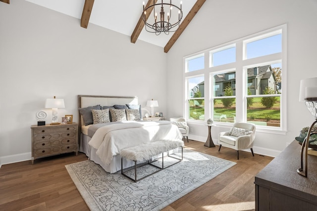 bedroom with multiple windows, beam ceiling, wood-type flooring, and a chandelier