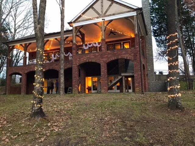 rear view of property featuring ceiling fan