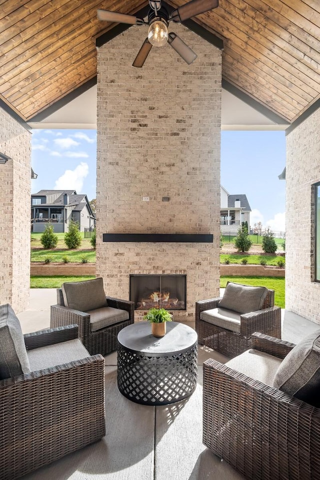 view of patio / terrace with an outdoor living space with a fireplace and ceiling fan