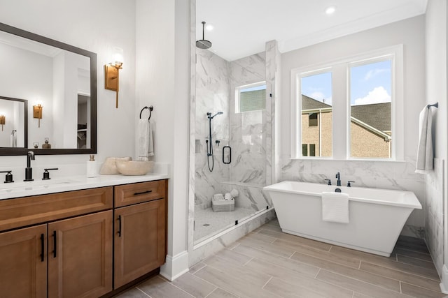 bathroom with shower with separate bathtub, ornamental molding, and vanity