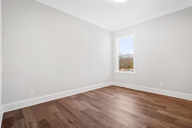 spare room featuring wood-type flooring and ornamental molding