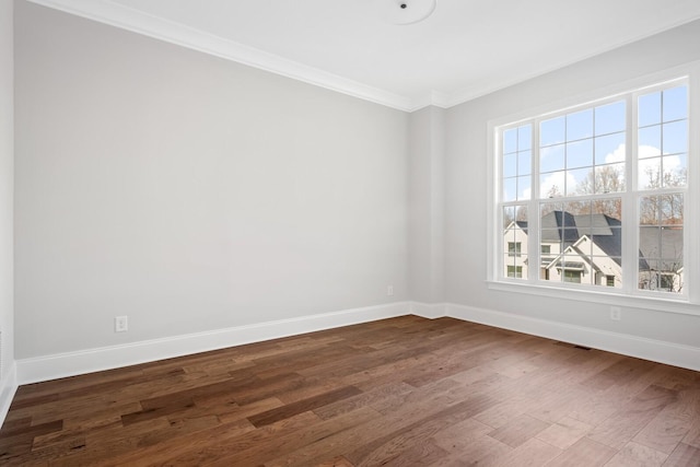 spare room with crown molding and dark hardwood / wood-style flooring