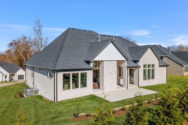 back of property featuring a lawn and a patio