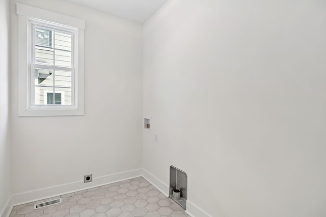 clothes washing area featuring washer hookup, light tile patterned floors, and electric dryer hookup