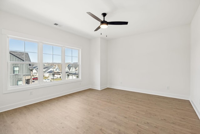 empty room with light hardwood / wood-style floors and ceiling fan