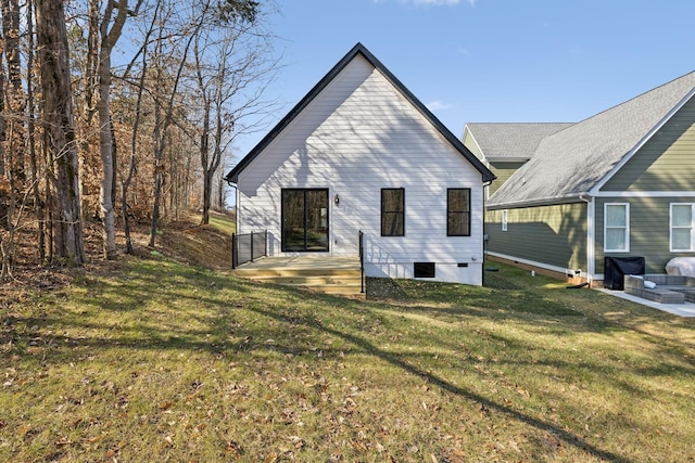 rear view of property featuring a lawn