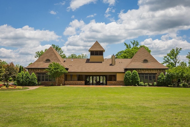 back of property with a lawn and french doors