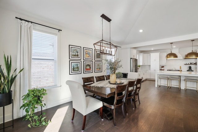 dining space with dark hardwood / wood-style floors and lofted ceiling