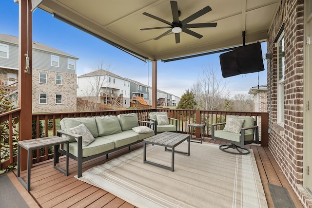 wooden deck with ceiling fan and an outdoor living space