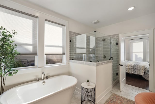 bathroom with shower with separate bathtub and tile patterned floors