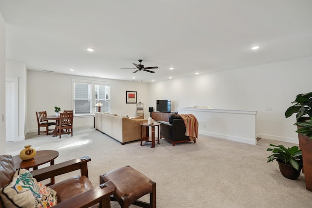 carpeted living room with ceiling fan