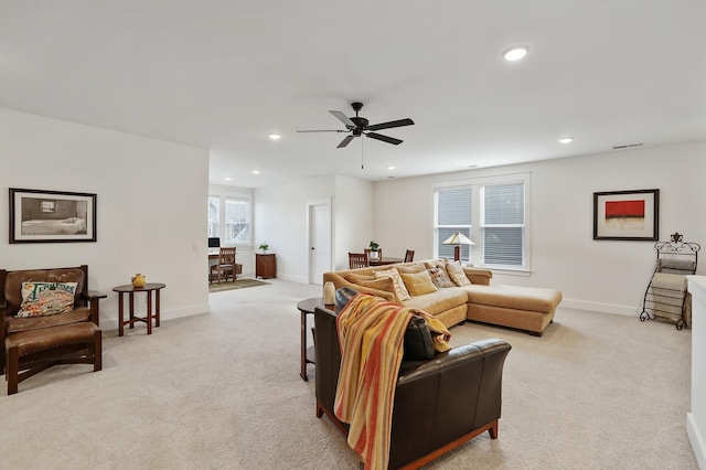 carpeted living room featuring ceiling fan