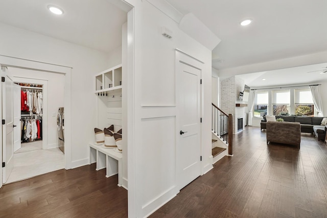 mudroom with washing machine and clothes dryer and dark wood-type flooring