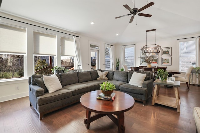 living room with ceiling fan, dark hardwood / wood-style floors, and lofted ceiling