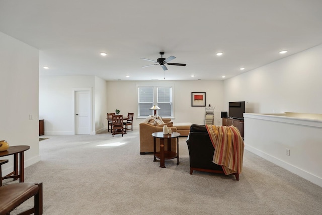 carpeted living room with ceiling fan