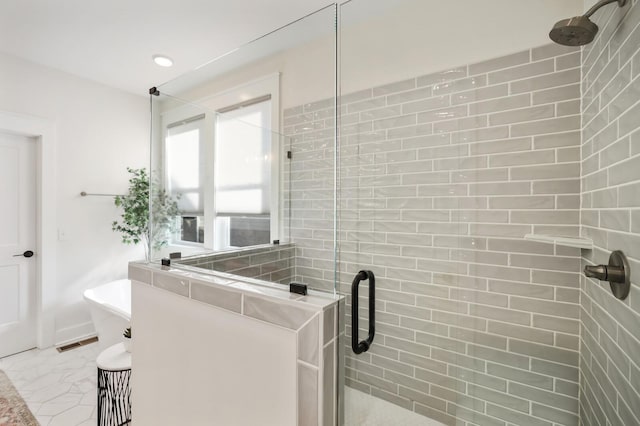 bathroom featuring separate shower and tub