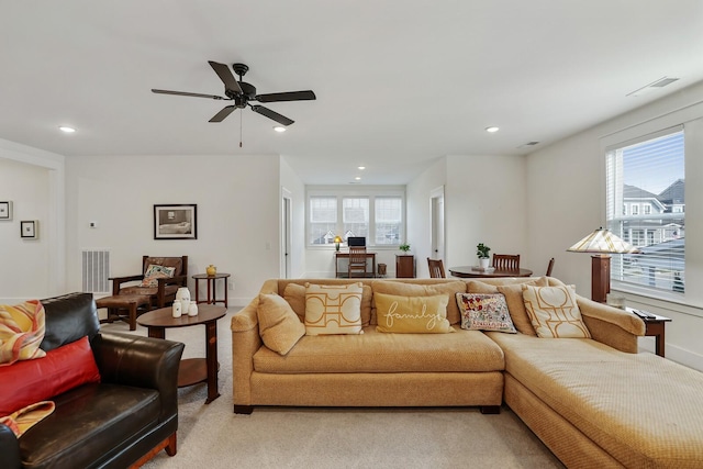 carpeted living room with ceiling fan and a wealth of natural light