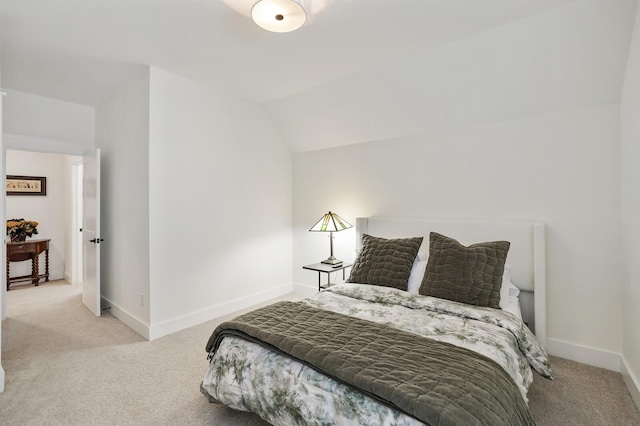 bedroom with light carpet and vaulted ceiling