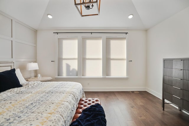 bedroom featuring dark wood-type flooring and vaulted ceiling