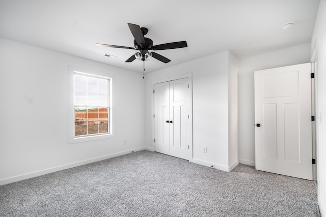 unfurnished bedroom with ceiling fan, carpet flooring, visible vents, baseboards, and a closet