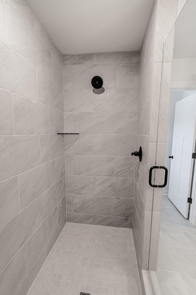 full bathroom featuring a stall shower and tile patterned flooring