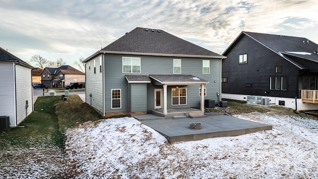 rear view of house featuring roof with shingles, a patio, and central air condition unit