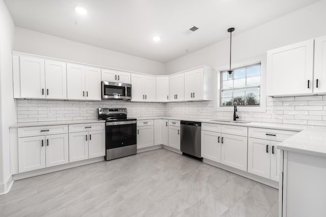 kitchen with stainless steel appliances, a sink, visible vents, white cabinetry, and light countertops